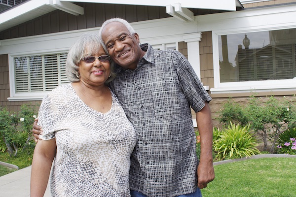 Retired couple smiling in yard